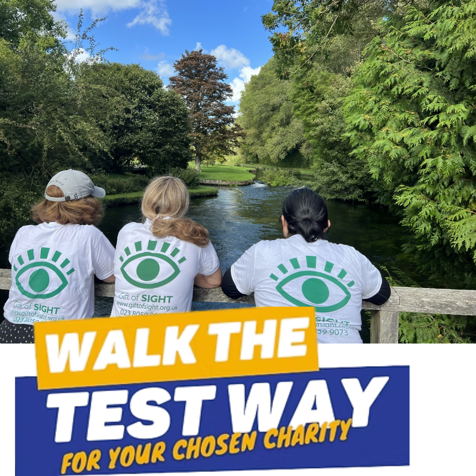 Walk the test way - three walkers looking at the River Test on the walk. 