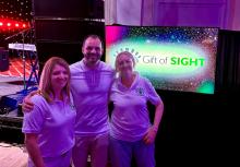 Liverpool LiveAid with Joe Marsden Jennie, Joe and Ailsa in front of Gift of Sight sign