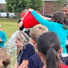 Teacher being soaked by an ice bucket of water