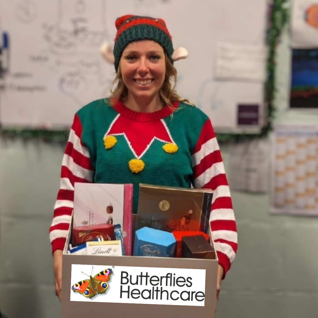 Ellie dressed as an Elf holding a hamper box 