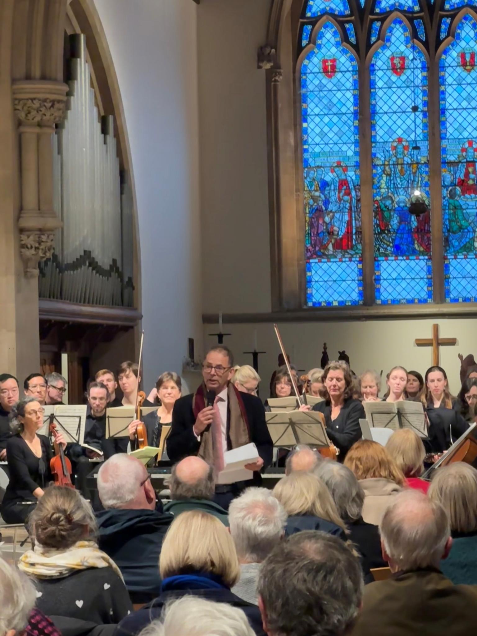 Prof Lotery speaking to packed concert audience 